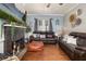 Comfortable living room showcasing hardwood floors, a brick fireplace, and stylish decor at 525 W Blue Springs Ave, Orange City, FL 32763