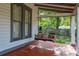 Relaxing porch swing with decorative pillows creates a comfortable seating area, perfect for enjoying the outdoors at 525 W Blue Springs Ave, Orange City, FL 32763