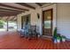 Charming front porch with rocking chairs and a decorative stained glass front door, creating a cozy entrance at 525 W Blue Springs Ave, Orange City, FL 32763