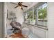 Relaxing screened porch with chair, ottoman, and outdoor view at 525 W Blue Springs Ave, Orange City, FL 32763