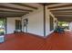 Wrap around front porch with stained wood floor and view of the home's exterior at 525 W Blue Springs Ave, Orange City, FL 32763