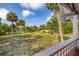 Beautiful porch view with palm trees across a large green lawn at 525 W Blue Springs Ave, Orange City, FL 32763