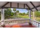 Scenic porch view of expansive lawn and palm trees in desirable community at 525 W Blue Springs Ave, Orange City, FL 32763