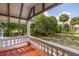 Relaxing porch view features mature trees in a lush green landscape at 525 W Blue Springs Ave, Orange City, FL 32763