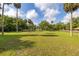 Expansive grassy property featuring mature trees and ample space, offering endless possibilities for outdoor enjoyment at 525 W Blue Springs Ave, Orange City, FL 32763