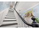 Elegant staircase with dark treads, white risers, and craftsman style railing at 525 W Blue Springs Ave, Orange City, FL 32763