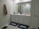 Bright bathroom featuring double sinks and large mirror at 537 S Andrea Cir, Haines City, FL 33844
