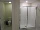 Bathroom featuring a toilet and tile and glass walk-in shower at 537 S Andrea Cir, Haines City, FL 33844