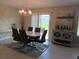 Dining room featuring modern table set, stylish light fixture, contemporary art, and sliding door access at 537 S Andrea Cir, Haines City, FL 33844