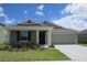 Attractive home boasts a well-maintained lawn, attached garage, and a welcoming covered entrance at 537 S Andrea Cir, Haines City, FL 33844