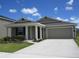 Inviting single-story house with a spacious driveway, attached garage, and meticulously landscaped front yard at 537 S Andrea Cir, Haines City, FL 33844