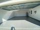 Spacious garage with sealed concrete flooring, an overhead door, and electrical panel at 537 S Andrea Cir, Haines City, FL 33844