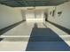 Spacious two-car garage featuring an epoxy floor, perfect for storage and vehicles at 537 S Andrea Cir, Haines City, FL 33844