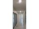 Hallway with ceramic floors and three large decorative mirrors at 537 S Andrea Cir, Haines City, FL 33844