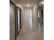 Hallway with ceramic floors and three large decorative mirrors at 537 S Andrea Cir, Haines City, FL 33844