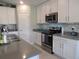 Modern kitchen featuring stainless steel appliances and white cabinets at 537 S Andrea Cir, Haines City, FL 33844