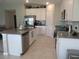 Open kitchen with stainless steel appliances and stone countertops at 537 S Andrea Cir, Haines City, FL 33844