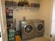 Laundry room featuring modern washer and dryer units and shelving for storage at 537 S Andrea Cir, Haines City, FL 33844