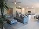 Inviting living area with a large sectional sofa, leading into a modern, open kitchen and dining area at 537 S Andrea Cir, Haines City, FL 33844