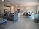 Open-concept living space featuring a modern sectional sofa, dining area, and bright kitchen at 537 S Andrea Cir, Haines City, FL 33844