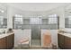 Modern bathroom features dual sinks, granite counters, tile floors, and a glass-enclosed shower at 561 Tapatio Ln, Kissimmee, FL 34759