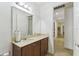 Bathroom with large mirror, brown vanity, and tiled flooring at 561 Tapatio Ln, Kissimmee, FL 34759