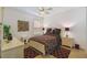 Comfortable bedroom with neutral tones, ceiling fan, and tiled floor at 561 Tapatio Ln, Kissimmee, FL 34759