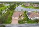 Beautiful lakefront home with lush landscaping, paver driveway, and tile roof at 561 Tapatio Ln, Kissimmee, FL 34759