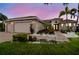 Inviting home with lush landscaping, brick driveway, and a three-car garage, perfect for serene living at 561 Tapatio Ln, Kissimmee, FL 34759