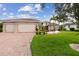 Charming single-story home featuring a brick driveway, three-car garage, and meticulously maintained lawn at 561 Tapatio Ln, Kissimmee, FL 34759