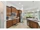 Spacious kitchen with stainless steel appliances, custom cabinetry, and walk-in pantry offers ample space and storage at 561 Tapatio Ln, Kissimmee, FL 34759