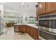Modern kitchen with stainless steel appliances, dark wood cabinets, and an open design for seamless entertaining at 561 Tapatio Ln, Kissimmee, FL 34759