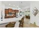 An open kitchen with stainless appliances, quartz countertops, and barstool seating offers a bright and modern space at 561 Tapatio Ln, Kissimmee, FL 34759