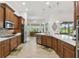 Well-appointed kitchen with stainless steel appliances, custom cabinetry, and an open layout to the dining area at 561 Tapatio Ln, Kissimmee, FL 34759