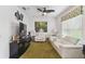 Cozy living room with plush white sofas, green carpet, and contemporary artwork at 561 Tapatio Ln, Kissimmee, FL 34759