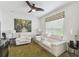 Living room with modern ceiling fan, plush seating and bright, natural light at 561 Tapatio Ln, Kissimmee, FL 34759