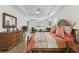 Open main bedroom with a ceiling fan, windows, wood furniture, and a comfortable bed with light bedding at 561 Tapatio Ln, Kissimmee, FL 34759