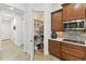 Pantry and kitchen with stainless steel appliances, custom cabinetry, and ample storage for an organized cooking space at 561 Tapatio Ln, Kissimmee, FL 34759