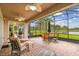 Enjoy outdoor living on this screened-in patio with brick flooring and views of the lake at 561 Tapatio Ln, Kissimmee, FL 34759