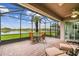 Relaxing screened patio with comfortable seating and tranquil lake views for outdoor enjoyment at 561 Tapatio Ln, Kissimmee, FL 34759