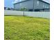 Spacious backyard featuring a lush lawn, privacy fence, and a small palm tree offering a private outdoor oasis at 5725 Iron Brand Rd, St Cloud, FL 34771