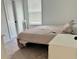Comfortable bedroom with a neutral color palette, plush carpet, and a large window with natural light at 5725 Iron Brand Rd, St Cloud, FL 34771