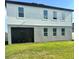 Back exterior view of home featuring a screened lanai and multiple windows offering plenty of natural light at 5725 Iron Brand Rd, St Cloud, FL 34771