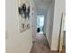 Bright hallway featuring neutral decor and a view into a room with a window at 5725 Iron Brand Rd, St Cloud, FL 34771