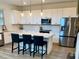 Bright kitchen with an island, pendant lighting, stainless appliances, and white shaker cabinets at 5725 Iron Brand Rd, St Cloud, FL 34771