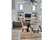 Elegant living room featuring soaring ceilings, modern fireplace and decor, and an open dining area at 5725 Iron Brand Rd, St Cloud, FL 34771