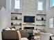 Elegant living room featuring soaring ceilings, modern fireplace and decor, and an open dining area at 5725 Iron Brand Rd, St Cloud, FL 34771