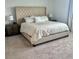 The primary bedroom suite offers a tufted headboard and plush bedding for a luxurious feel at 5725 Iron Brand Rd, St Cloud, FL 34771