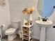 Cozy powder room featuring a pedestal sink, decorative accents, and a stylish mirror at 5725 Iron Brand Rd, St Cloud, FL 34771