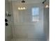 Contemporary walk-in shower with sleek tile, overhead and handheld showerheads, and glass door at 5725 Iron Brand Rd, St Cloud, FL 34771